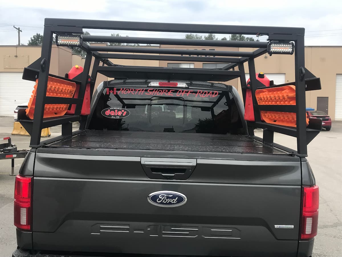 Rear view of Ford F-150 with custom off-road racks, traction boards, and fuel canisters installed in Surrey by Ridge Rack