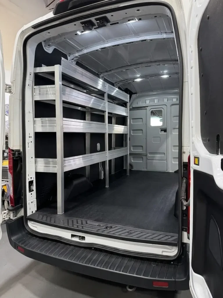 Organized shelving along the side of a work van interior