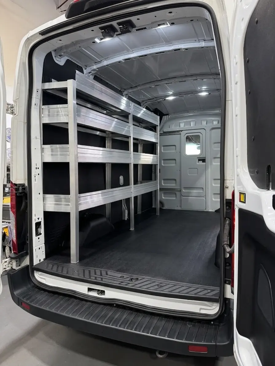 Organized shelving along the side of a work van interior